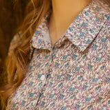 Close-up of a person wearing a floral patterned shirt with bunny print