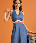 Front view of a vintage-inspired halter jumpsuit with color-blocked waistband and v-neck