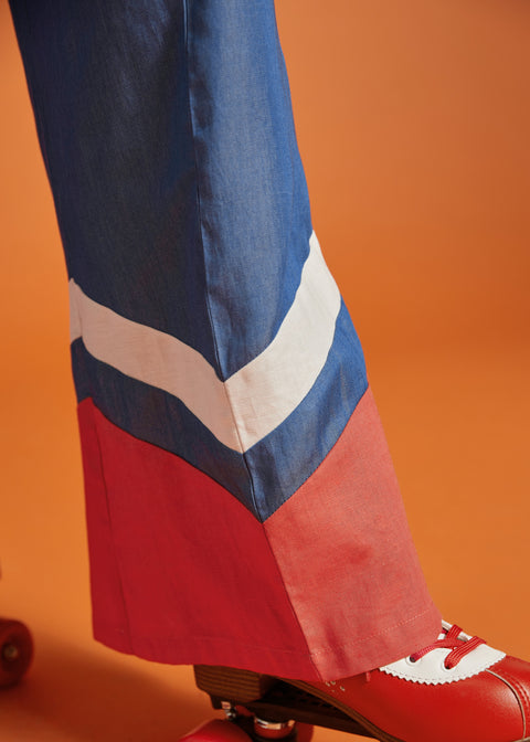 Close-up of the contrast chevron hem on a wide-leg blue jumpsuit.