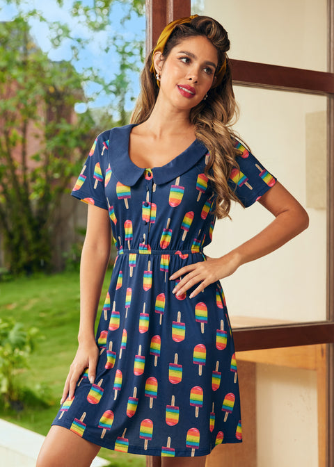 Model wearing navy dress with rainbow popsicle print and Peter Pan collar, front view