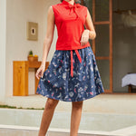 Styled outfit pairing red bow top with printed skirt