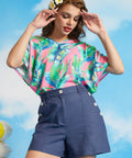 Woman wearing blue linen blend high-waisted sailor shorts with decorative buttons.