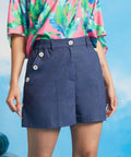 Front view of linen-cotton sailor shorts with decorative side buttons and front pockets.