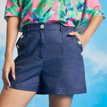 Woman wearing vintage-inspired linen blend shorts with wide-leg silhouette.