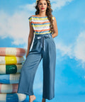 Woman wearing vintage-inspired dusty blue cropped wide leg trousers with paperbag waist and tie belt