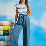 Woman wearing vintage-inspired dusty blue cropped wide leg trousers with paperbag waist and tie belt