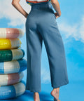 Back view of dusty blue cropped wide leg pants with high waist and relaxed vintage-inspired silhouette