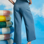 Back view of dusty blue cropped wide leg pants with high waist and relaxed vintage-inspired silhouette