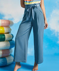 Front view of dusty blue paperbag waist cropped pants with pockets and wide leg silhouette