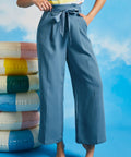 Woman posing in dusty blue vintage-inspired cropped wide leg pants with sash belt and side pockets
