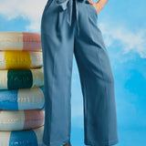 Woman posing in dusty blue vintage-inspired cropped wide leg pants with sash belt and side pockets