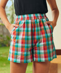 Front detail of colorful plaid cotton shorts with pockets