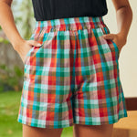 Front detail of colorful plaid cotton shorts with pockets