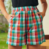 Front detail of colorful plaid cotton shorts with pockets