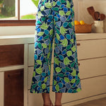Person wearing blue patterned pants in a kitchen setting