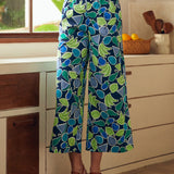Person wearing blue patterned pants in a kitchen setting