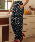 Woman wearing black polka dot pants in a kitchen setting
