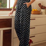 Woman wearing black polka dot pants in a kitchen setting