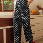 Wide leg palazzo pants with elastic waistband and polka dot print, front view