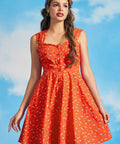Woman wearing orange vintage-inspired sundress with synchronized swimmer novelty print and sweetheart neckline