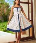 Woman wearing sailboat print fit and flare dress with square neckline, front view