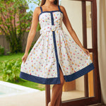 Woman wearing sailboat print fit and flare dress with square neckline, front view
