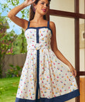 Woman wearing a dress with sailboat pattern outdoors