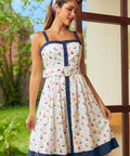 Woman wearing a white dress with colorful sailboat pattern in a vintage style