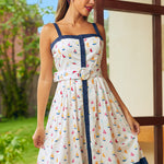 Woman wearing a white dress with colorful sailboat pattern in a vintage style