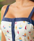 Close-up of button-front bodice and square neckline detail with navy trim