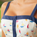 Close-up of button-front bodice and square neckline detail with navy trim