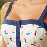 Close-up of button-front bodice and square neckline detail with navy trim