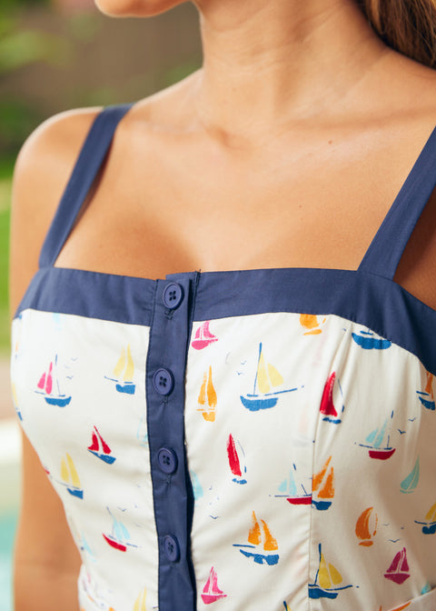 Close-up of button-front bodice and square neckline detail with navy trim