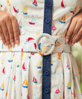 Close-up of matching belt and waist detail on sailboat print dress