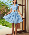 Woman wearing blue seaside print Breezy Boardwalk Shirt Dress with belt, front view