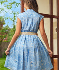 Back view of blue seaside print dress showing gathered waist and full skirt