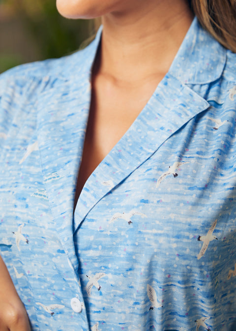 Close-up of collar and button-front bodice on blue coastal print shirt dress