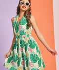 Woman wearing tropical fruit print sleeveless fit-and-flare dress with collared neckline