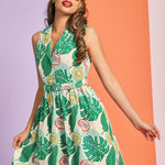Woman wearing tropical fruit print sleeveless fit-and-flare dress with collared neckline