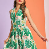 Woman wearing tropical fruit print sleeveless fit-and-flare dress with collared neckline
