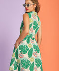 Back view of tropical fruit print fit-and-flare dress with belted waist