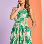 Woman wearing colorful citrus print cotton dress with cat-eye sunglasses