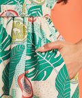 Close-up of side pocket detail on tropical fruit print dress