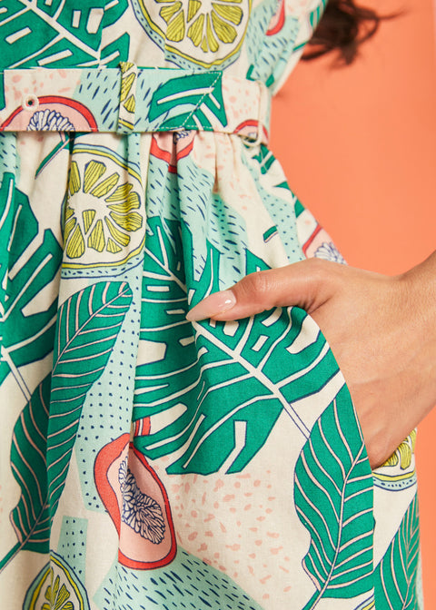 Close-up of side pocket detail on tropical fruit print dress