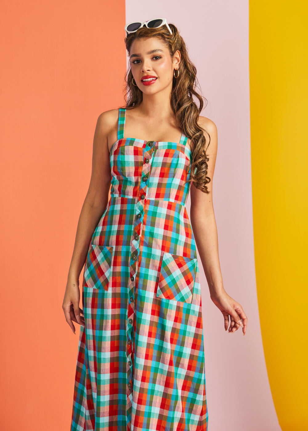 Woman modeling sleeveless plaid sundress with square neckline
