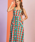 Woman wearing a colorful plaid midi summer dress with front pockets