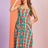 Woman wearing a colorful plaid midi summer dress with front pockets