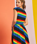 Back angled view of rainbow striped fit and flare dress with cap sleeves and waist seam detail