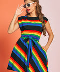 Front view of rainbow striped retro-inspired dress with cap sleeves, pockets, and removable tie belt