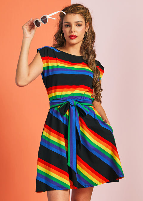 Woman wearing rainbow stripe fit and flare dress with boatneck neckline and sash tie waist